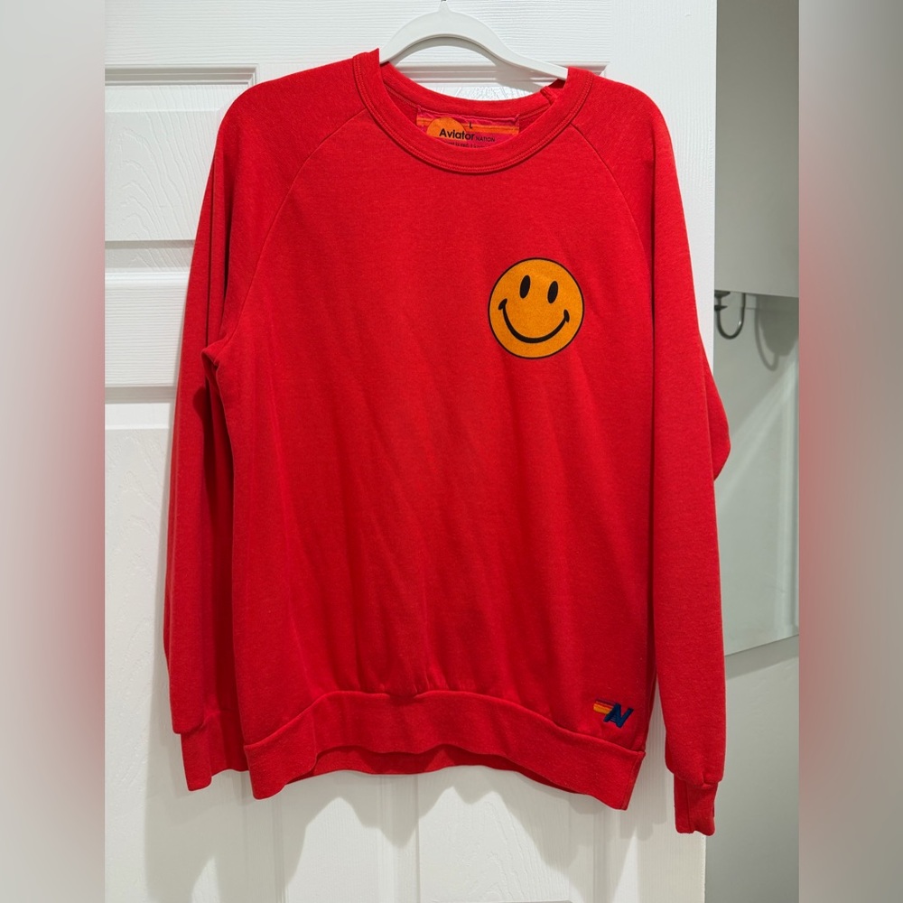 Large Aviator Nation red smiley face crewneck